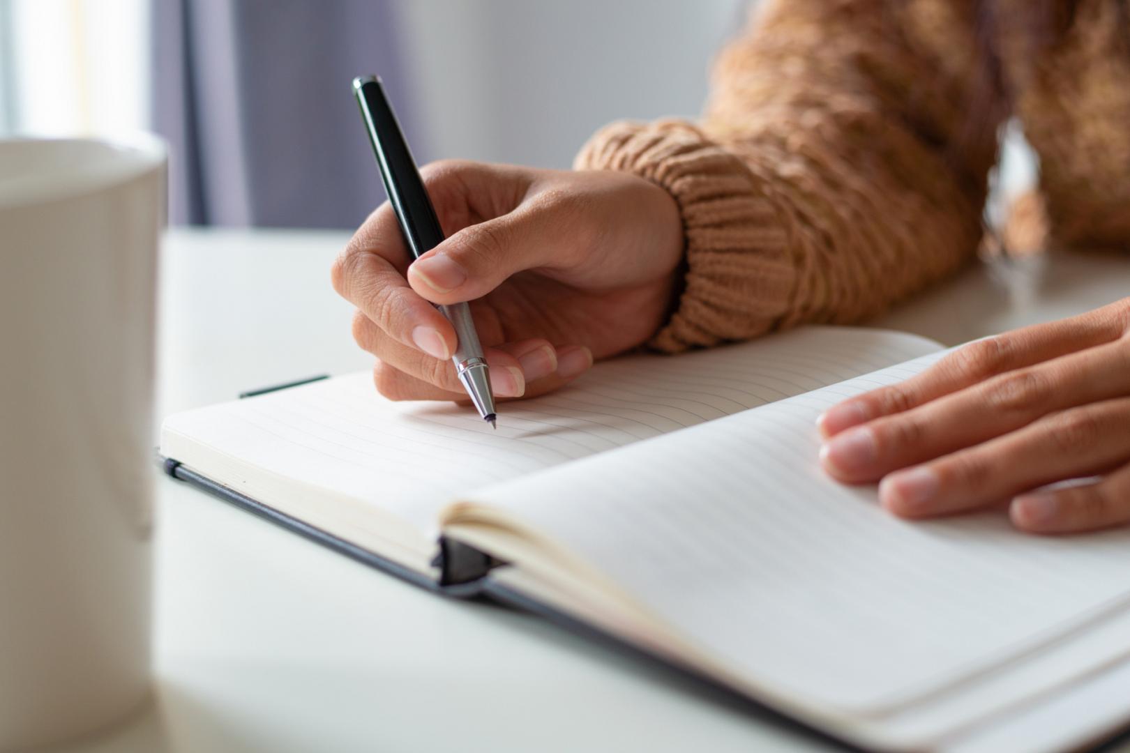 close up woman sitting table planning schedule